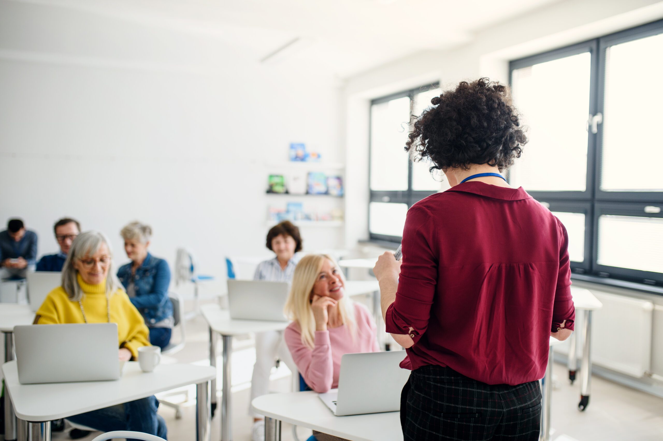 Group of senior people attending computer and technology education class.